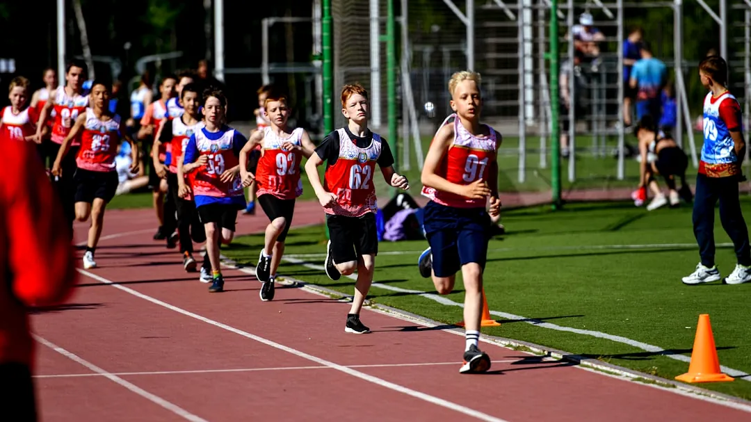 a group of young people running on a track