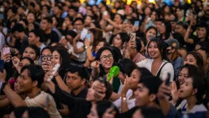 a large group of people taking pictures with their cell phones