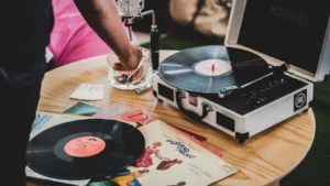 Close-up of a vinyl record player with classic albums, showcasing vintage music vibes.