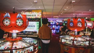 man wearing brown jacket inside arcade