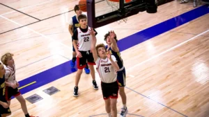 a group of young men playing a game of basketball