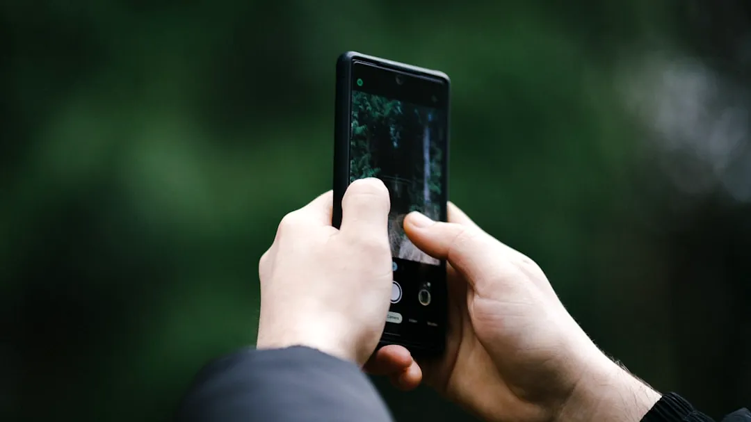 a person taking a picture with a cell phone