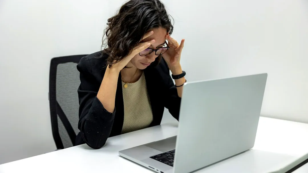 a woman sitting in front of a laptop computer