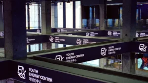 Modern interior with signs for youth energy center.