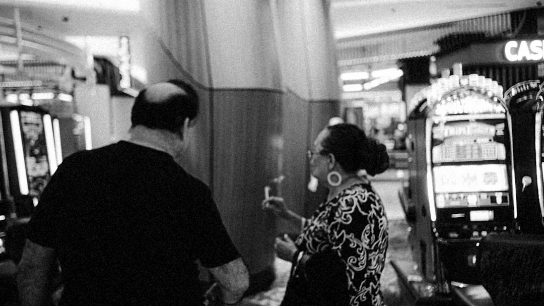 a man and a woman standing in front of slot machines